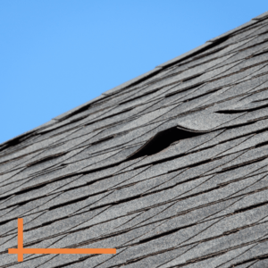 photo of damaged roof shingles