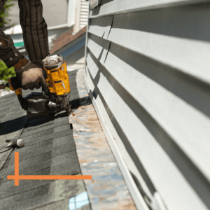 roofer repairing a damaged roof seal with a nail gun