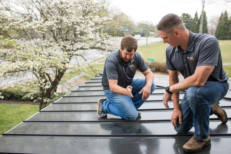 roofing team members working on roof
