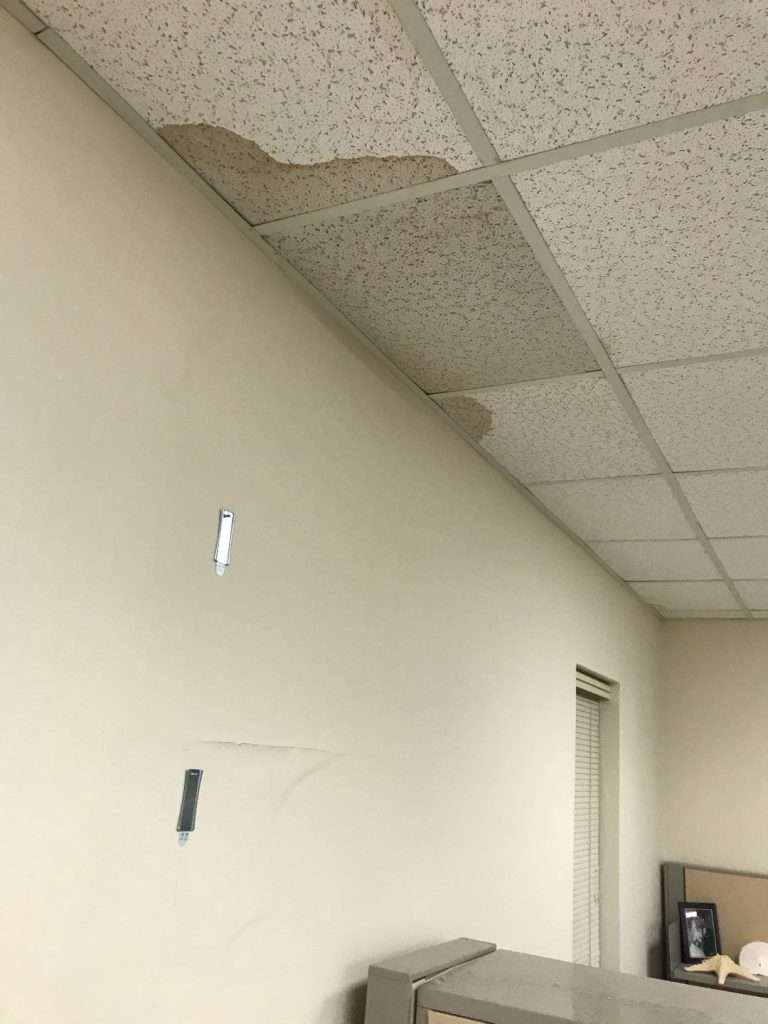 interior water damage to drop ceiling tiles due to roofing leak