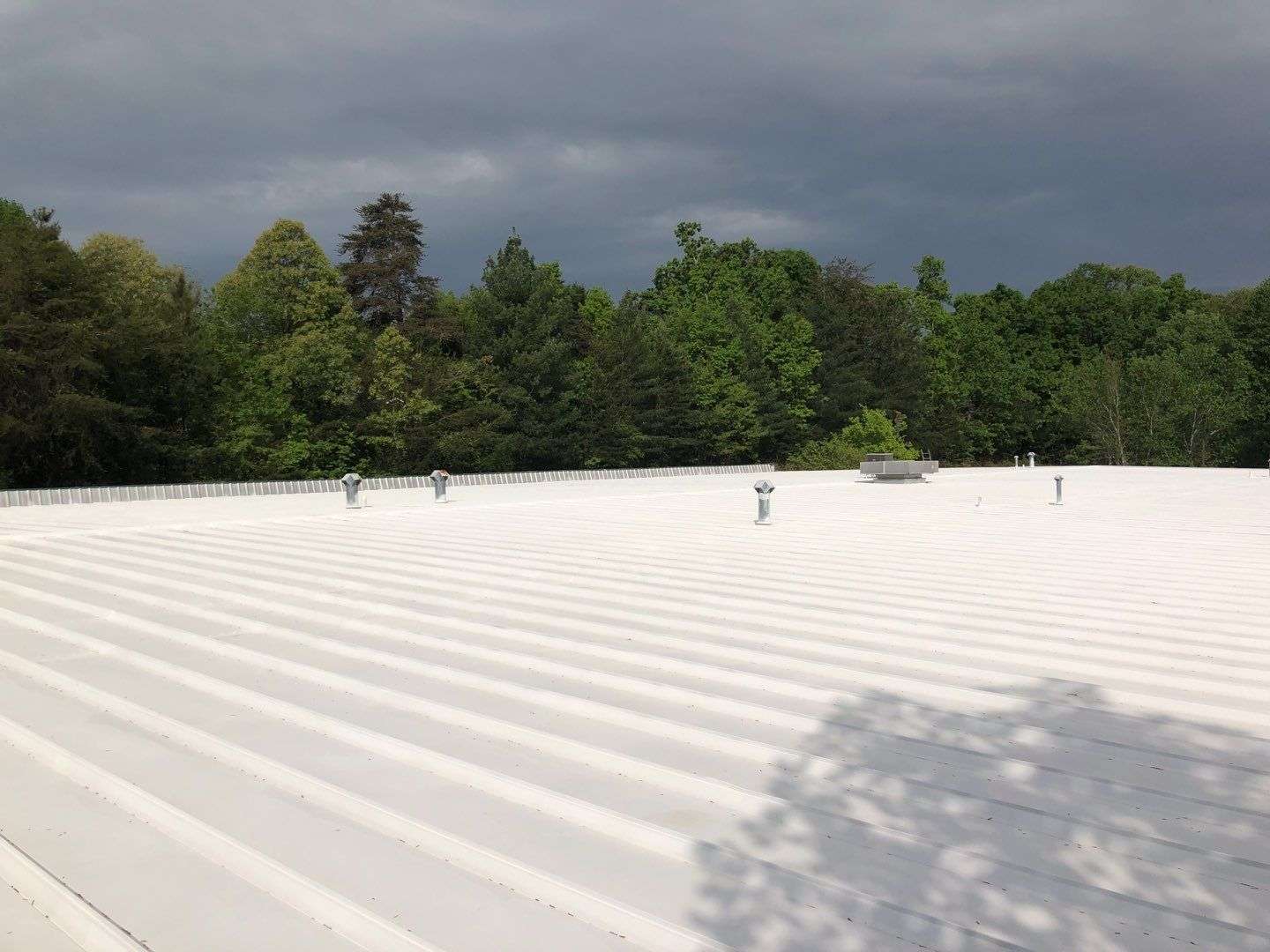 recently recoated commercial roof in white
