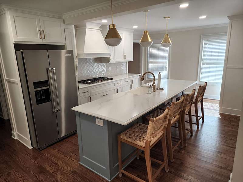 residential kitchen with island and range hood after a remodeling job from skyline contracting