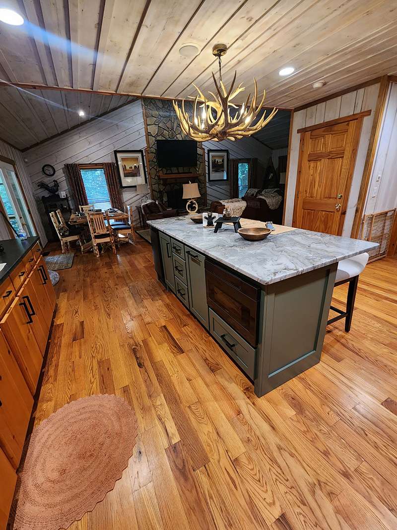 interior kitchen after remodeling with grey countertops and black trim