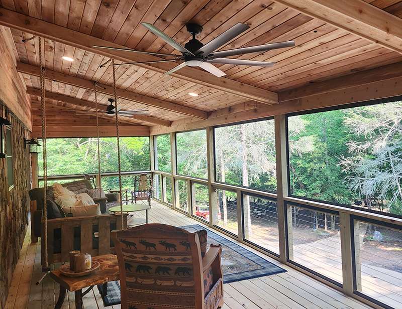 Exterior porch with exposed wood and celing fans after skyline contracting remodeling job