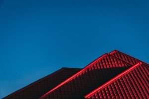 a red metal roof against a blue sky background