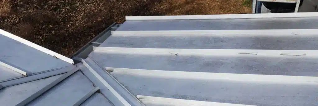 Metal roof repair in Gainesville by Skyline Contracting in GA showing repaired seams and fasteners before winter