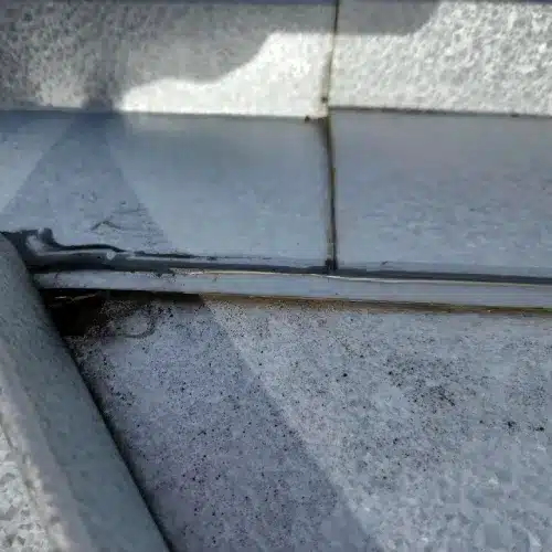 Metal roof seam repair with fresh sealant applied for leak prevention during metal roof repair by Skyline Contracting in GA