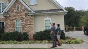 Photo of Gainesville roof inspection company assessing a property.