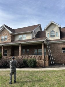 Professional roof inspection completed with Skyline Contracting team member on the roof talking to team member on the ground in Gainesville, GA