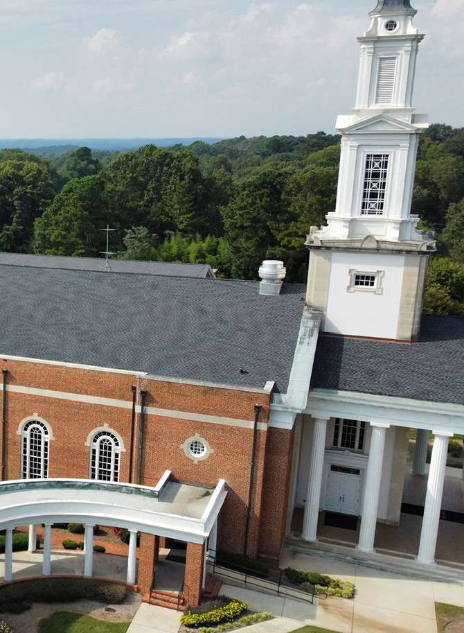 isometric view of a red brick church roof covered with grey shingles