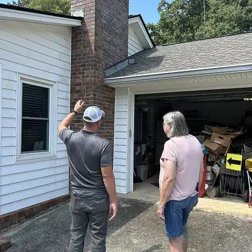 Contractor discussing roof inspection results with homeowner by Skyline Contracting in Gainesville