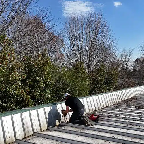 Professional roofer performing repair work during roof inspections in Gainesville by Skyline Contracting