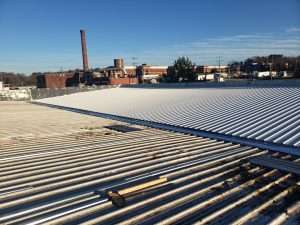 a metal flat roof in need of repair in Gainesville, GA