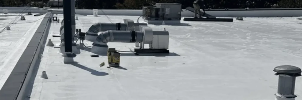 Technician performing maintenance on a commercial flat roof to increase ROI and extend roof lifespan – Skyline Contracting.