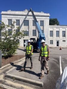 Skyline Contracting staff walking behind a commercial building in a process of commercial roof repairs in Gainesville, GA