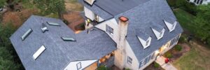 Aerial view of a house with grey roof and white siding by roof installation company in Gainesville, GA