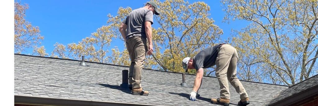 Skyline Contracting team members on a brown roof in a process of Roof inspection in Gainesville