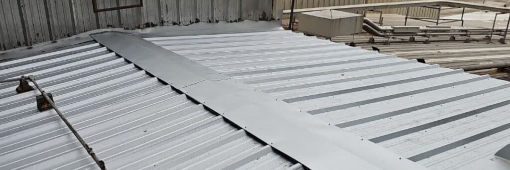 Metal roof with a prominent seam running down the center installed by certified roofing specialists in Gainesville, GA