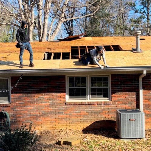 Skyline contracting roofing contractors in a process of a roof replacement on a brick house
