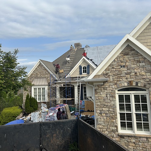Roofer repairing roof during steep roof replacement and chimney restoration by Skyline Roofing Company in Lake Lanier