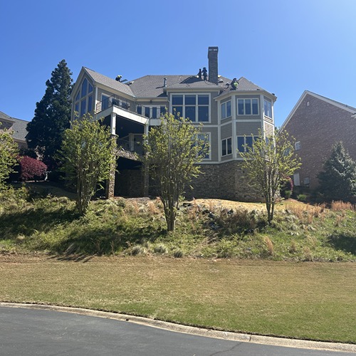 Front view of a stunning house undergoing roof repair by Skyline Roofing Company in Lake Lanier