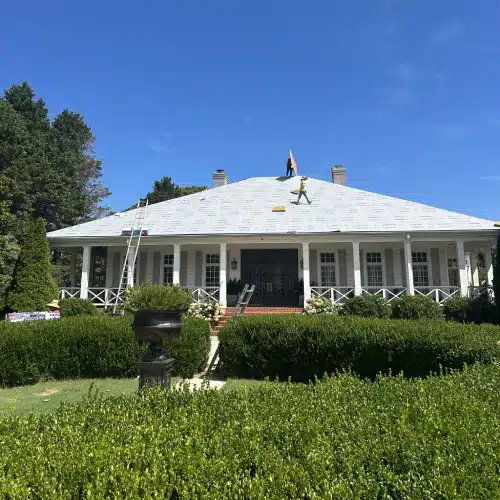 Roofing crew working on a spacious residential roof highlighting critical labor and material components in a roofing estimate by Skyline Contracting