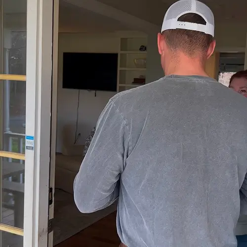 Homeowner consulting with roofing contractor indoors, highlighting key questions to ask a roofing contractor by Skyline Contracting