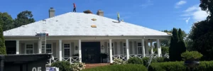 Professional roofers installing underlayment on a large residential roof, demonstrating essential components included in a roofing estimate by Skyline Contracting