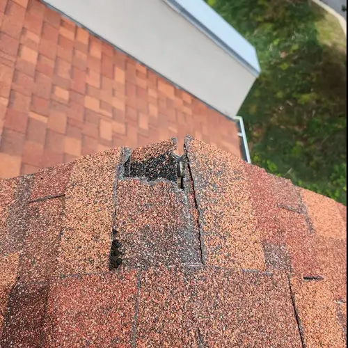 Signs You Need a New Roof – Damaged Shingles on Roof Ridge
