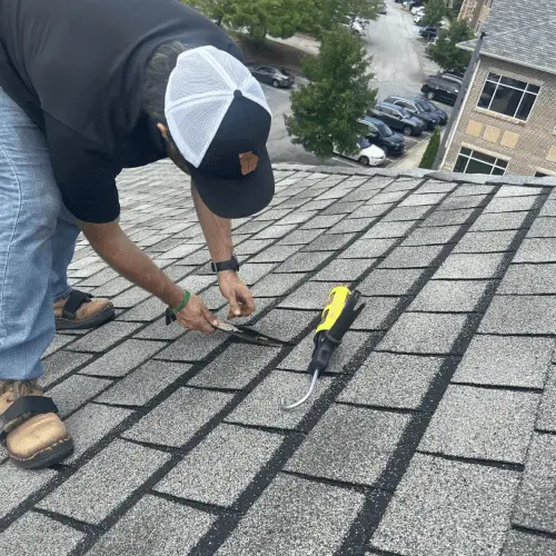 Commercial roofing specialist inspecting a flat roof to enhance maintenance ROI and roof lifespan – Skyline Contracting.