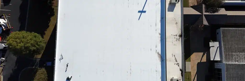 Aerial view of a commercial roof during inspection by Skyline Contracting in Gainesville, GA