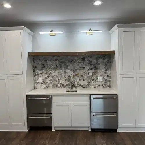 Clean kitchen interior after roofing project cleanup with white cabinets and stone mosaic backsplash what to expect during a roof replacement by Skyline Contracting in Gainesville