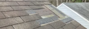 Mismatched shingles and roof patch area, signs of a roof leak by Skyline Contracting in Gainesville