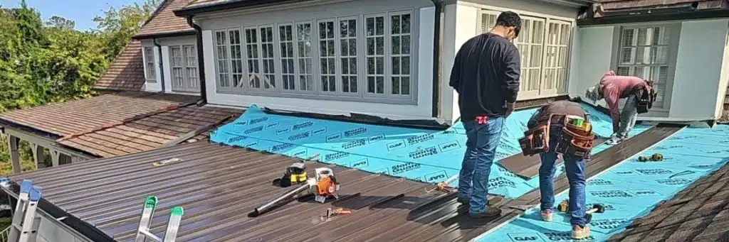 Professional roofers installing metal roof panels showcasing residential roofing materials benefits by Skyline Contracting in Gainesville, GA