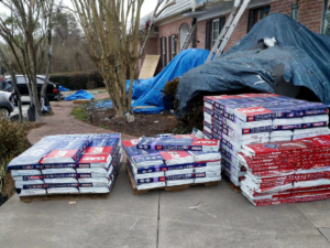 Pallets of GAF roofing shingles delivered to a home for a roof replacement project