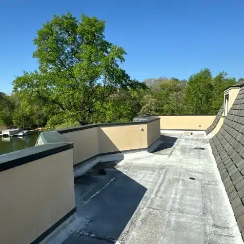 A wide view of a residential flat roof replacement project showcasing modern design by Skyline Contracting | Roofing Contractor & Remodeler in GA