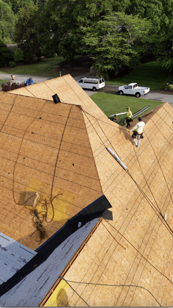 A roof deck being installed on a home with visible underlayment and plywood sheathing, showing why choose Skyline Contracting for roofing in Omaha by Anchor Roofing.