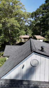 A newly installed roof with dark shingles and a vented gable, showing why choose Skyline Contracting for roofing in Omaha by Anchor Roofing.