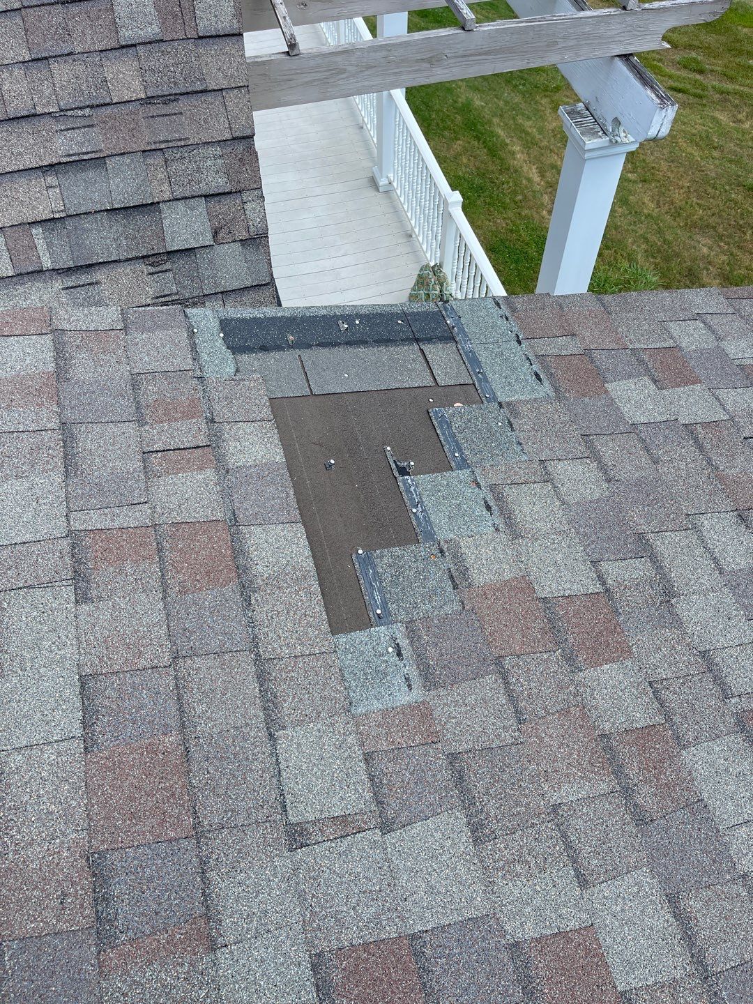 A section of missing asphalt shingles on a residential roof slope exposing the dark underlayment paper, highlighting a critical inspection item on a roofing maintenance checklist roofing service in Gainesville by Skyline Contracting