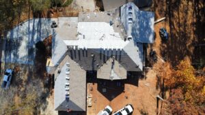 An aerial top-down view of an ongoing residential roof replacement following roof damage insurance claim rules roofing service in Gainesville by Skyline Contracting