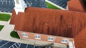 Aerial view of red shingle church roof church roofing contractor service in Gainesville GA by Skyline Contracting