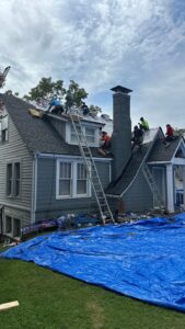 Roofing crew replacing shingles following a hail damage roof guide repair in Gainesville, GA by Skyline Contracting