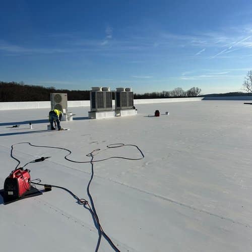 Skyline Contracting crew working on a white commercial roof, GAF master certified contractor commercial roofing in Gainesville, GA by Skyline Contracting